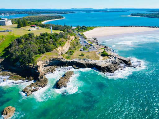 An aerial view of Yamba Main Beach against the ocean on a sunny day