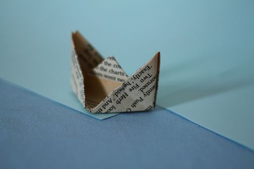 A paper boat isolated on blue background