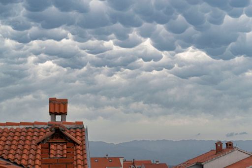 A closeup of a quaint town under the Mammatus clouds