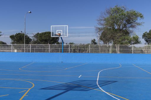 A closeup shot of an outdoors basketball field painted in blue