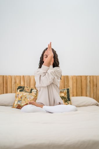 A closeup shot of a white Caucasian woman doing yoga in her room