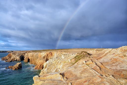 A beautiful shot of rainbow across the rocky coast in Brittany, France