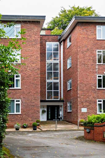 Apartment building brick built in the 1970's 4 floors flat roof style homes