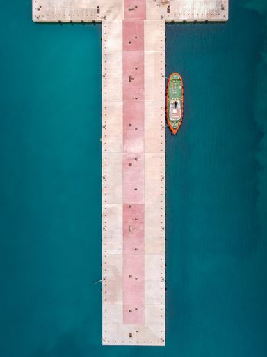 A vertical top view of a boat near the port of Sigri, located in Lesvos, Greece