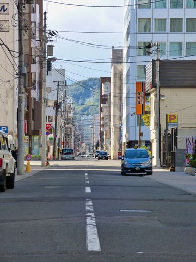 A vertical shot of an urban street at sunset in Hokkaido, Japan