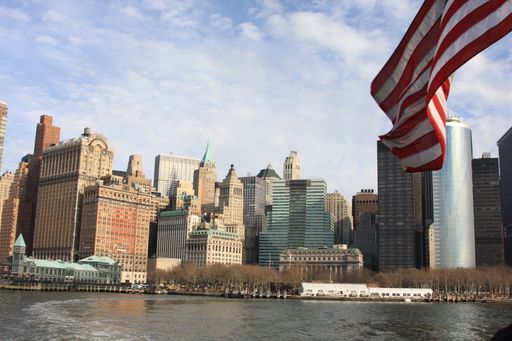 The skyline of New York City with the American Flag in foreground