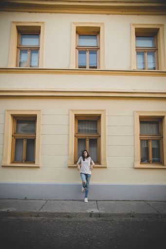 A vertical shot of a beautiful white Caucasian girl posing on street