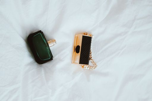 A top view of perfume flacons on a white fabric