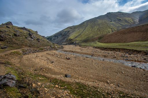 A scenic view of a mountain range with a creek in the foreground. Landmannalaugar, Iceland.