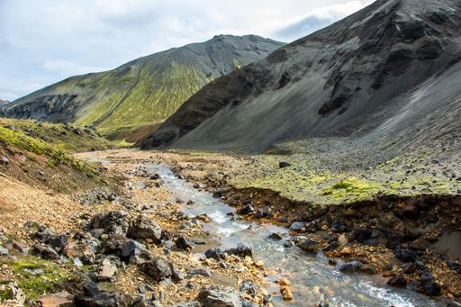 A scenic view of a mountain range with a creek in the foreground. Landmannalaugar, Iceland.