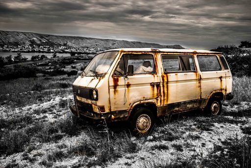 An old abandoned vintage vehicle in the meadow