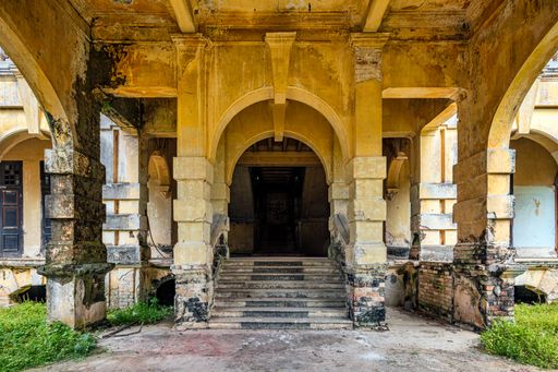 An archway of an abandoned mansion in malaysia during daytime