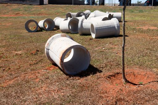The concrete Sewer pipes laid out on the grass waiting to be installed