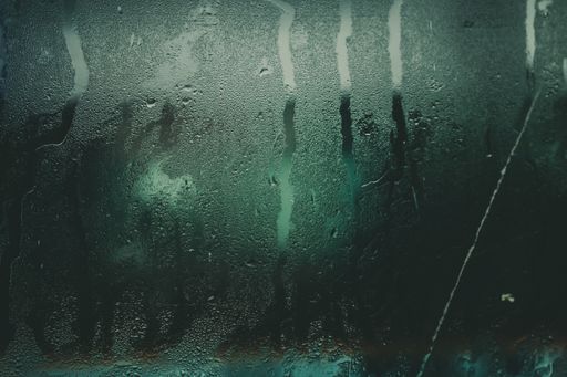 A closeup shot of a steamed glass with raindrops