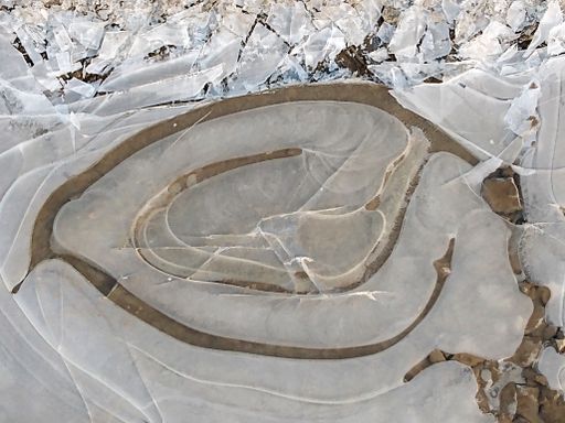 A high angle shot of thin ice in the ground during winter
