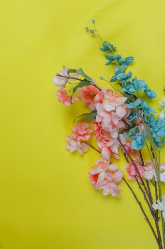 A beautiful colorful bouquet on a vertical yellow background with a copy space