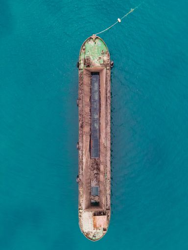 A top view shot of a green hopper barge moored at Sigri, Lesvos, Greece