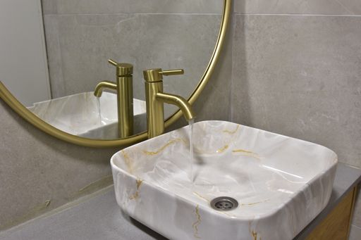 A close-up shot of a bathroom interior in cozy colors with a modern bathtub