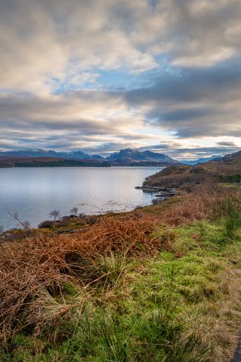 A vertical high angle shot of a small lake under the cloudy sky Highlands, Scotland