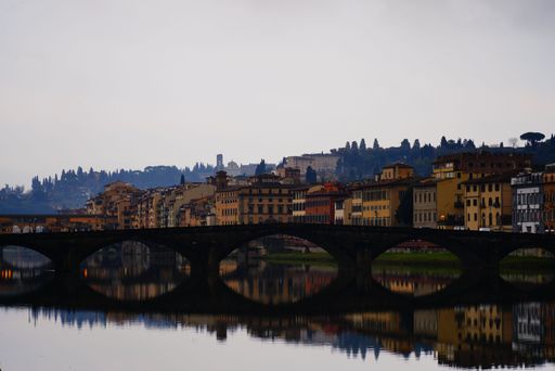 A scenic view of a bridge in Florence, Italy on a cloudy day