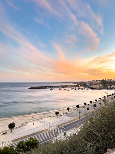 View over the beach called Praia Da Vasco da Gama in Sines, Portugal at sunset