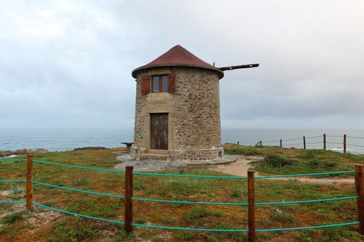 A small barn in the Northern Littoral Natural Park surrounded by the sea under a stormy sky in Portugal