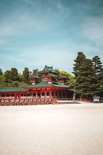 A vertical shot of a red historic shrine in Japan