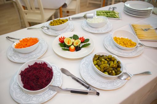 The salad ingredients and decorations on the table under the lights in a room
