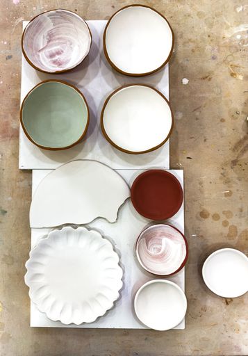 A selection of bisque ceramics that has been glazed and ready for the second glaze firing