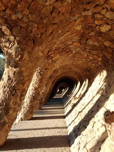 An arcade of masonry stone columns in Park Guell Barcelona, Gaudi modernism