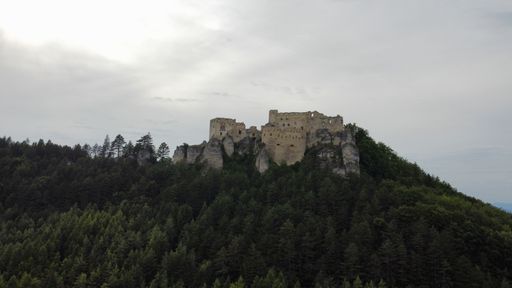 An imposing castle stands majestically atop a mountain