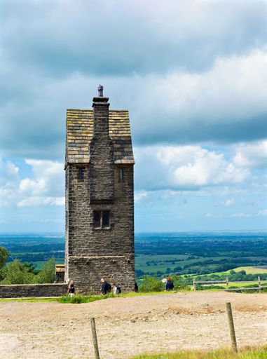 The historic Pigeon tower at Rivington Pike in Lancashire under a bright blue sky