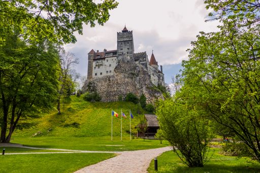 A scenic view of the Bran Castle and park in its foreground