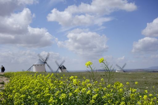 A tranquil scenery of fields with windmills in La Mancha, Spain
