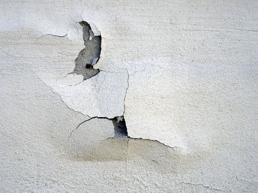 A closeup shot of cracked paint on the concrete wall