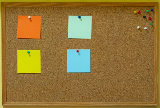 A bulletin board with pinned papers, a blank space in the right