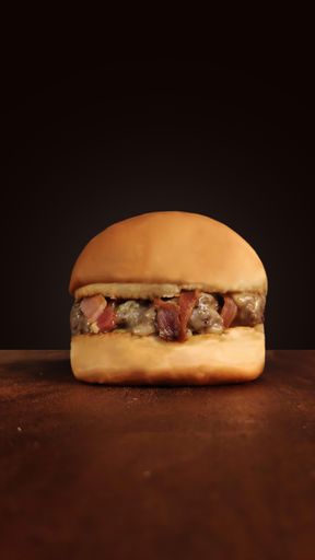 A vertical shot of a hamburger on the wooden table isolated on black background