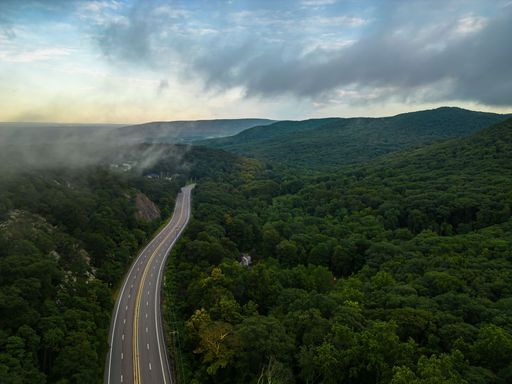 An aerial view over Storm King Mountain in upstate, New York during a golden sunrise