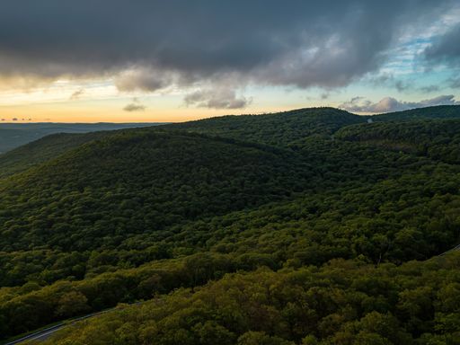 An aerial view over Storm King Mountain in upstate, New York during a golden sunrise
