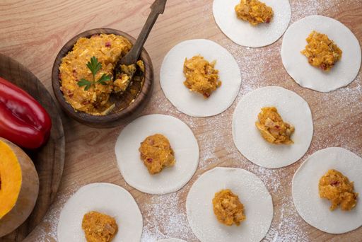 The ingredients for making Argentinian empanadas stuffed with vegetables and squash on wooden surface