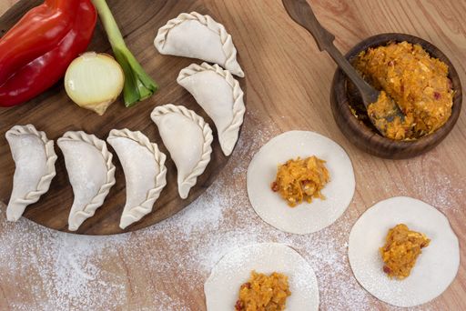The ingredients for making Argentinian empanadas stuffed with vegetables and squash on wooden surface