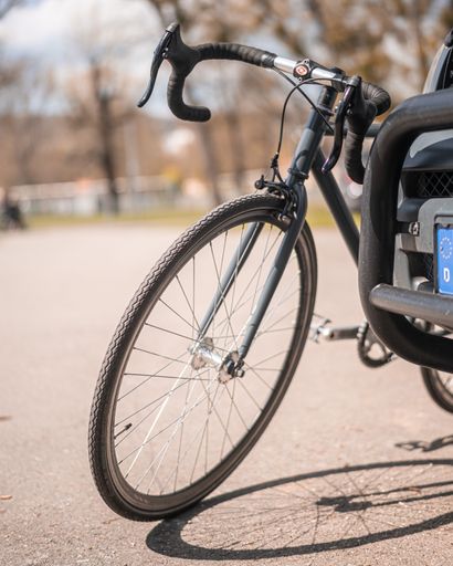 A vertical shot of a black bicycle on the street