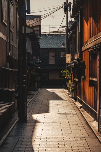 A narrow street lined with red brick, located between two buildings