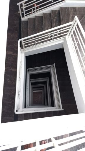 A vertical shot of a staircase in an apartment