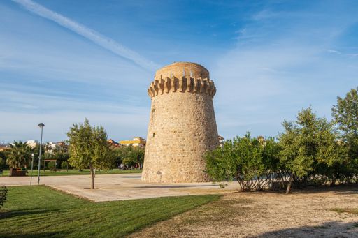 The Torre de Piles on the Piles Beach under the sunlight and a blue sky in Spain