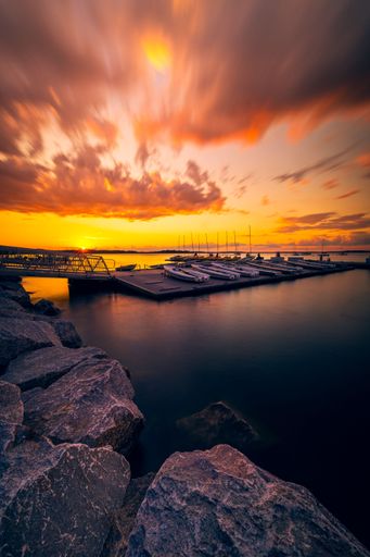 A majestic sunset over Lake Mendota with boats in the foreground in Madison, Wisconsin