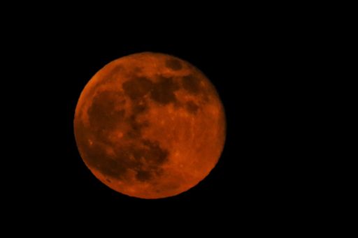 A closeup shot of the full moon on the night sky background