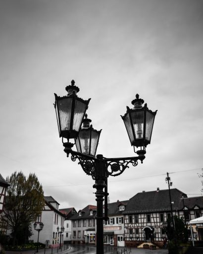 A beautiful vintage lamp in an old town. Black and white photo