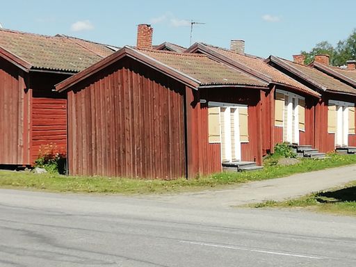 A row of brown rustic wooden cabins