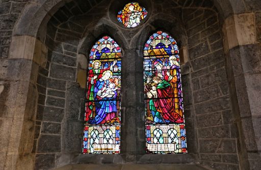 A closeup shot of the beautiful stained-glass windows of a catholic church